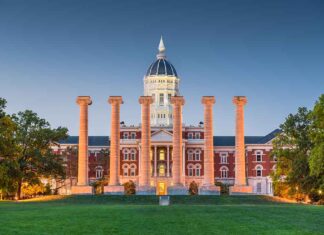 Historic building with columns at sunset, front view.