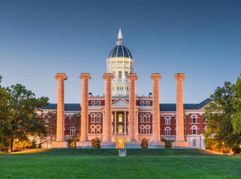 Historic building with columns at sunset, front view.