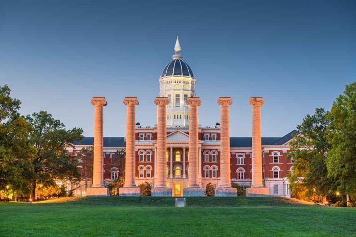 Historic building with columns at sunset, front view.