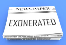 Newspaper with EXONERATED headline on the front page.