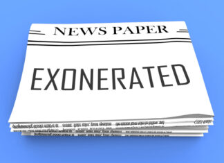 Newspaper with EXONERATED headline on the front page.