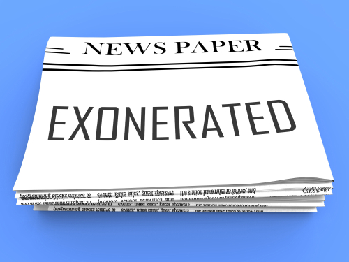 Newspaper with EXONERATED headline on the front page.