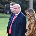 Donald Trump with wife Melania and son Barron walking together.