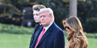 Donald Trump with wife Melania and son Barron walking together.