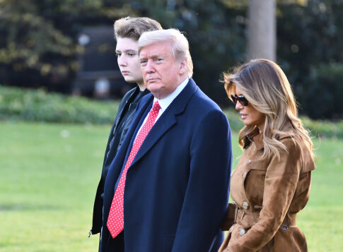 Donald Trump with wife Melania and son Barron walking together.