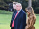 Donald Trump with wife Melania and son Barron walking together.