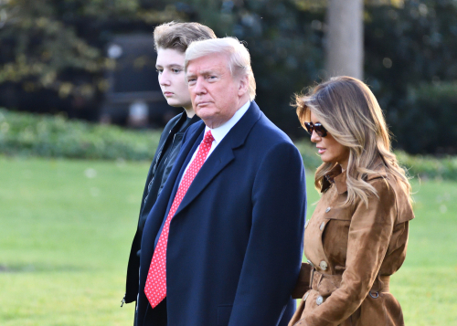 Donald Trump with wife Melania and son Barron walking together.