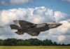 F-35 fighter jet taking off from runway.