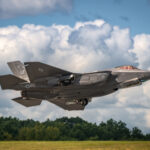 F-35 fighter jet taking off from runway.