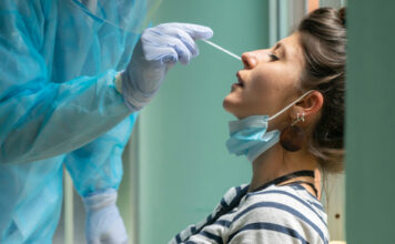 Person receiving a nasal swab COVID-19 test.