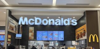 People standing in line at McDonald's inside mall.