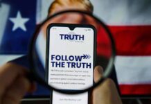 Phone displaying Truth Social app over American flag background.