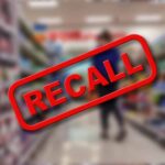 Recall text over blurred supermarket background.