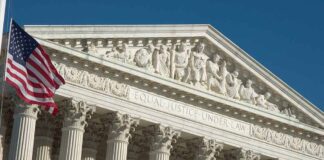 Supreme Court building facade with American flag.