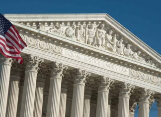 Supreme Court building facade with American flag.