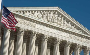 Supreme Court building facade with American flag.