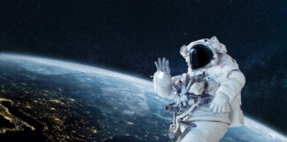 Astronaut floating in space above Earth, waving.