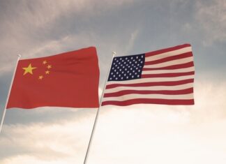 Chinese and American flags waving side by side.