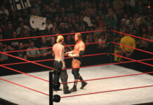 Wrestlers facing off in a ring at a match.