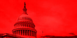 United States Capitol building under red-hued sky.