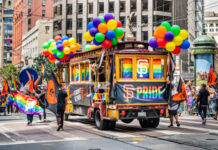 San Francisco trolley adorned with pride decorations and balloons.