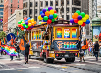 San Francisco trolley adorned with pride decorations and balloons.