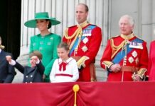 Royal family members on a balcony during a public event.