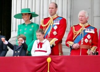 Royal family members on a balcony during a public event.