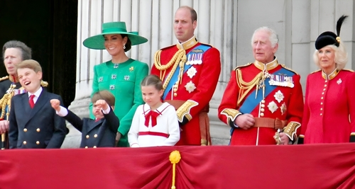 Royal family members on a balcony during a public event.