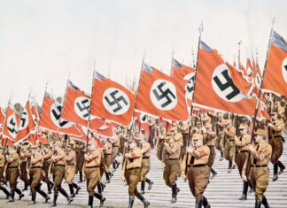 Nazi soldiers marching with swastika flags, World War II.