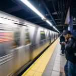 People waiting at 42nd Street subway station, New York City.