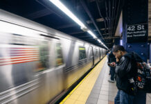 People waiting at 42nd Street subway station, New York City.