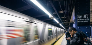 People waiting at 42nd Street subway station, New York City.