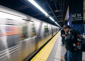 People waiting at 42nd Street subway station, New York City.