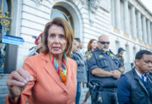 Nancy Pelosi speaking outside a government building.