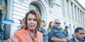 Nancy Pelosi speaking outside a government building.