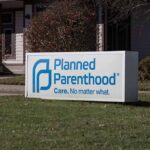 Planned Parenthood sign outside building.