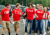 Group wearing CNN is Fake News shirts thumbs up