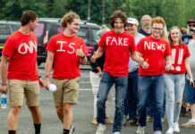 Group wearing CNN is Fake News shirts thumbs up