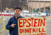 Man holding Epstein didn't kill himself 2020 sign.