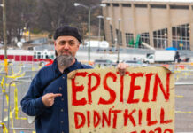 Man holding Epstein didn't kill himself 2020 sign.