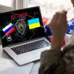 Laptop displaying ATTACK with Russian and Ukrainian flags