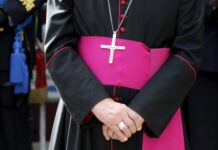 Close-up of a cleric with cross necklace.