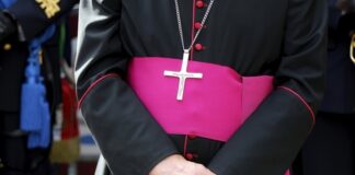 Close-up of a cleric with cross necklace.