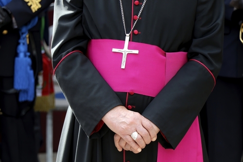 Close-up of a cleric with cross necklace.