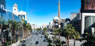 Las Vegas Boulevard with Eiffel Tower replica and hotels.