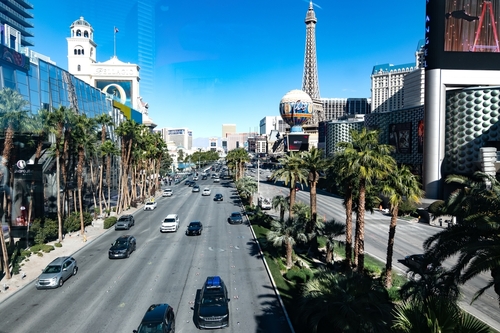 Las Vegas Boulevard with Eiffel Tower replica and hotels.