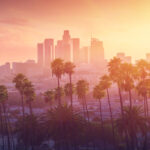 Los Angeles skyline with palm trees at sunset.