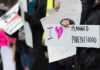 People holding signs supporting Planned Parenthood.