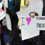 People holding signs supporting Planned Parenthood.